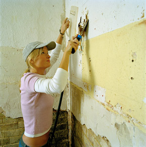 Professional wallpaper installation on a wall before the finish is complete